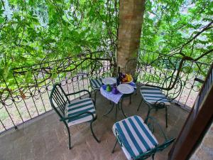 a patio with a table and chairs and a fence at Farmhouse in Todi with Pool & Theater Nearby in Chioano