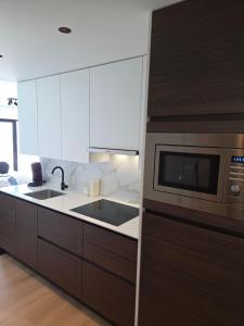 a kitchen with a sink and a microwave at MelCview in Westende-Bad