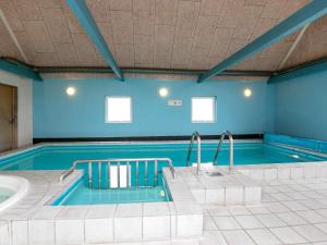 a large swimming pool with a tub in a room at 14 person holiday home in Løgstør-By Traum in Løgstør