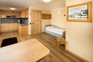 a small room with a bed and a table at Engadina Chalet in Livigno +45 photos