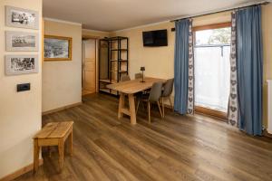 a dining room with a table and chairs and a window at Engadina Chalet in Livigno