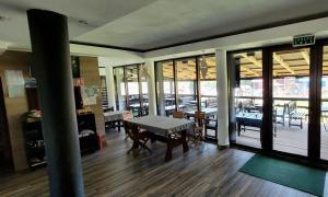 a room with a table and some tables and windows at La Belle Vie in Vartop