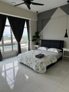 a bedroom with a bed and a large window at Damai Vacation Stay 7 pax 3 Free Parking in Shah Alam
