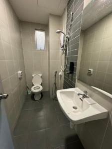 a bathroom with a sink and a toilet at Damai Vacation Stay 7 pax 3 Free Parking in Shah Alam