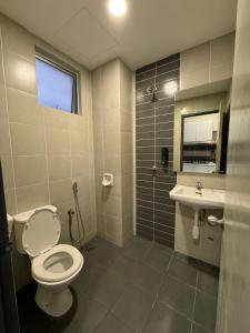 a bathroom with a toilet and a sink at Damai Vacation Stay 7 pax 3 Free Parking in Shah Alam