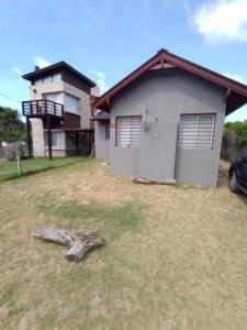 a house with a yard in front of it at Casa Don Lopez in Mar Azul