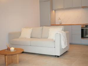 a living room with a white couch and a table at La verrière in Avignon