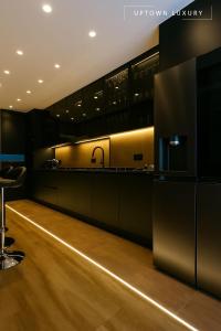 a kitchen with black cabinets and a sink at XIII 1d in Lisbon
