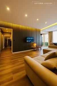 a living room with a couch and a tv on a wall at XIII 1d in Lisbon