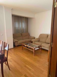 a living room with two couches and a coffee table at Apartamento amplio T3 Sao Bras de Alportel in São Brás de Alportel