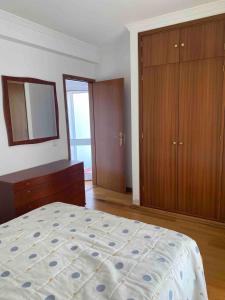 a bedroom with a bed and a dresser and a mirror at Apartamento amplio T3 Sao Bras de Alportel in São Brás de Alportel +16 photos