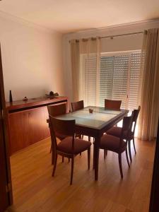 a dining room table and chairs in a room at Apartamento amplio T3 Sao Bras de Alportel in São Brás de Alportel