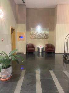 a waiting room with chairs and a table in a building at Bahrain Amwaj in Amwaj Island +21 photos