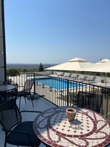 a patio with a table and chairs and a pool at Vila Slavonika in Slavonski Brod