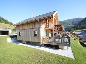 a small wooden house with a large deck at Chalet in Hohentauern am Skilift in Hohentauern