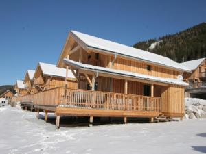 a row of log homes in the snow at Chalet in Hohentauern am Skilift in Hohentauern