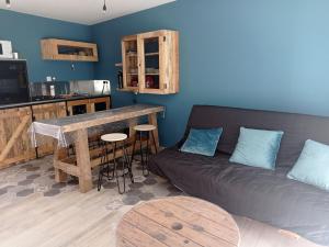 a living room with a couch and a table at L'Atelier in Coupray