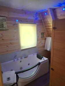 a large bath tub in a room with a window at Spa villas Higo in Žabljak