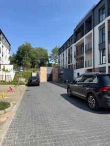 a car parked on a street next to a building at Apartamenty Cegielnia 2 Lux-Haus in Gorzów Wielkopolski