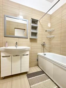 a bathroom with a sink and a tub and a mirror at Station Hostel in Atyrau +68 photos