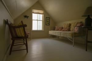 a living room with a couch and a chair at Charming 1-bedroom Waterfront Cottage in Morgan VT in Morgan