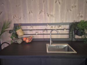 a kitchen counter with a sink and fruits and lights at Stunning 3-Bedroom Apartment at Feda Waterfront in Feda +87 photos