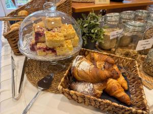 a display of bread and pastries on a table at Hotel am Bergl in Schweinfurt