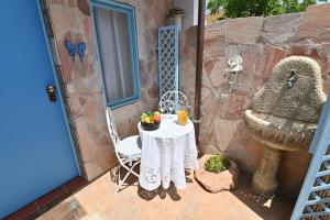 a table and chair on a patio with a sink at IzzHome Sea Style Apartment in Pula