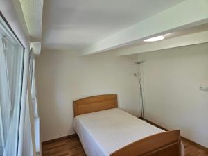 a small bedroom with a bed and a window at Nový park in Nitra
