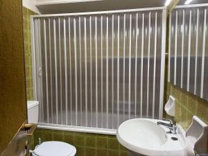 a bathroom with a toilet and a sink and a window at Dimora Colli Bassi in Pescasseroli +19 photos