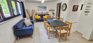 a living room with a blue couch and a table and chairs at Villa Maria in Trani