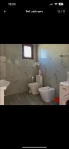 a bathroom with two sinks and two toilets at K Bougainville Albania in Orikum +30 photos