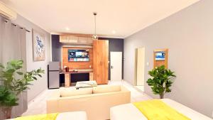 a living room with a couch and a kitchen at Nexus Luxury Lodge in Springs