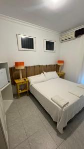 a bedroom with a bed and a table and two chairs at Hostal Playa Hidalgo in Rota
