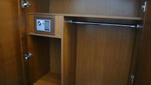 a wooden door with a microwave in a bathroom at Տաթևի կիրճ Gorge of Tatev in Tatʼev