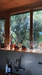a kitchen counter with a window above a sink at CASA LOBO - La Pedrera -Luxury- Diseño junto al Mar in La Pedrera
