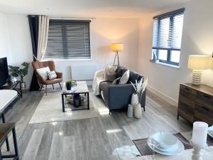 a living room with a couch and a table at Beach Haven - FREE PARKING - Luxury 2 bedroom 2 bathroom Town Centre Apartment by Coastline Retreats in Bournemouth