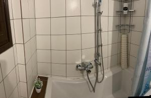 a shower in a bathroom with a tub at Jane's Beautiful Cottage, Eretria in Eretria +17 photos