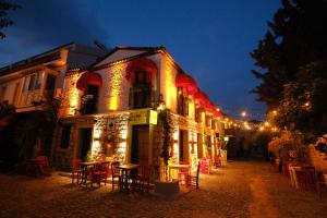 a building with lights on it at night at VoQ Alaçatı Hotel in Çeşme