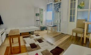 a living room with a couch and a table at F&D Cozy Corners in Edgware