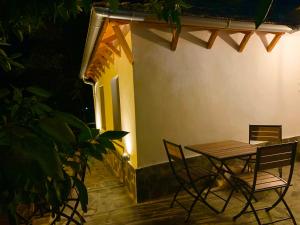 a table and chairs on a patio at night at Guest House Zverku - 1873 in Gjirokastër