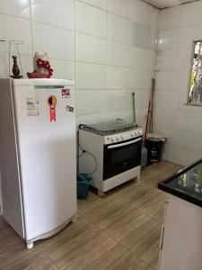 a kitchen with a stove and a refrigerator at Teresópolis Hostel in Teresópolis +15 photos
