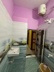 a bathroom with purple walls and a sink at M S , Homes in Tiruvannāmalai