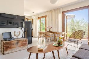 a living room with a couch and a table at Villa Hod 2BR Nature Suite in Ein Hod