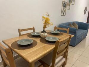 a wooden table with four chairs and a blue couch at DK Lodge in Kandy +6 photos