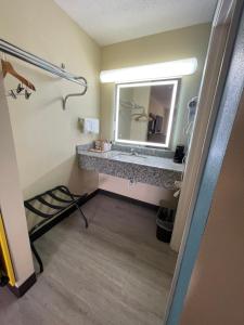 a bathroom with a sink and a mirror at Deerfield Inn in Parsons