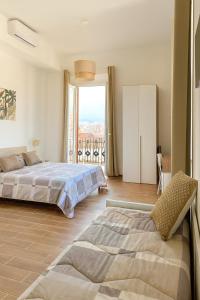 a bedroom with a large bed and a balcony at Le Tortorelle in La Spezia