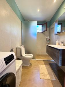a bathroom with a toilet and a sink at Join In Home in Pogoniá +39 photos
