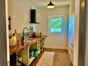 a kitchen with a sink and a window at Art Deco House Oceanview in Wicklow