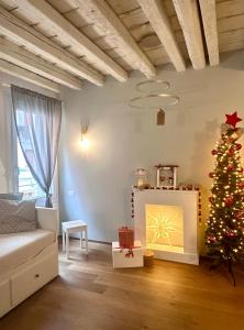 a living room with a christmas tree and a couch at Suite Apartment a tema Natale in centro storico "Gingerbread Suite" in Chioggia